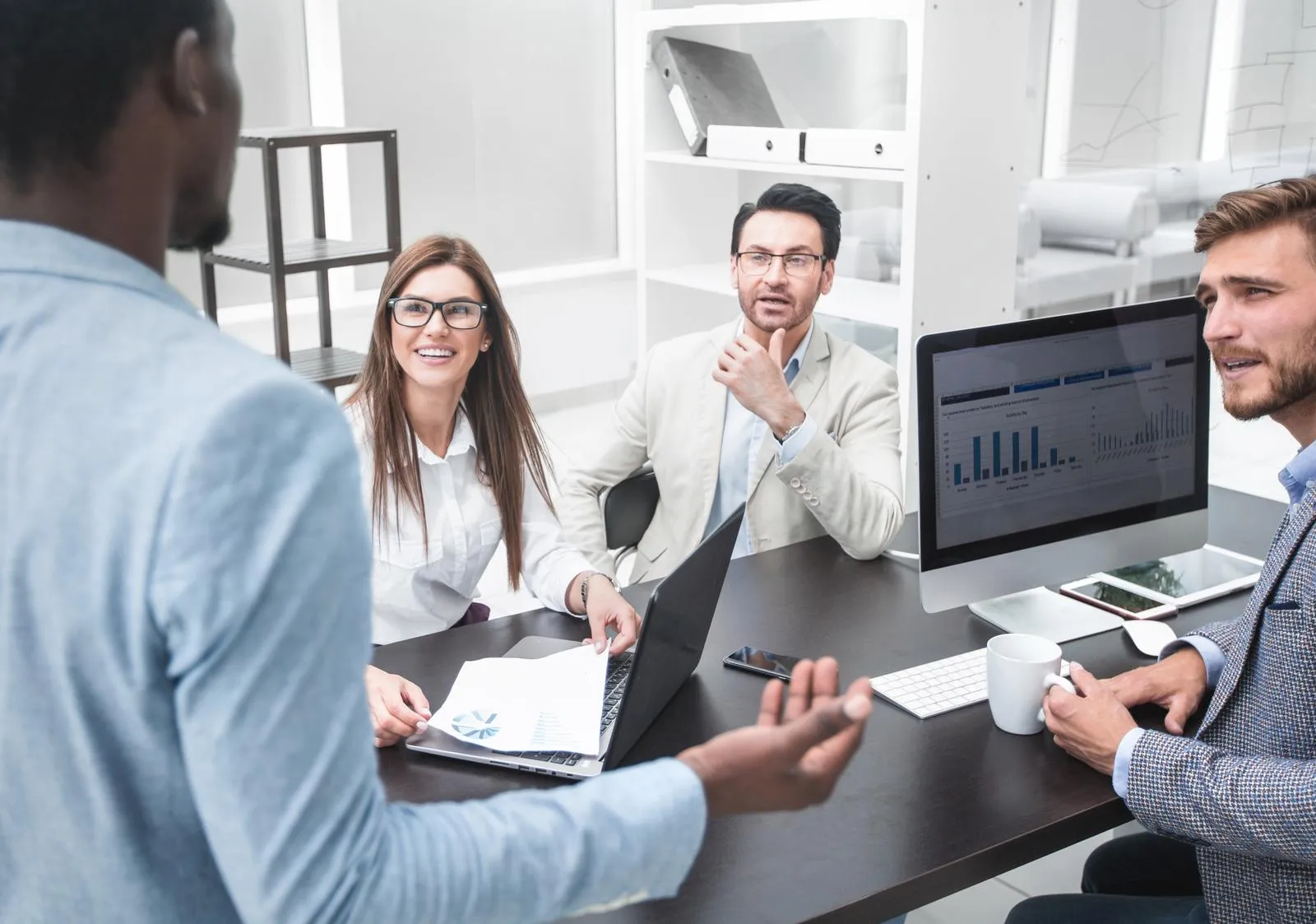 businessman talking with colleagues in the workplace